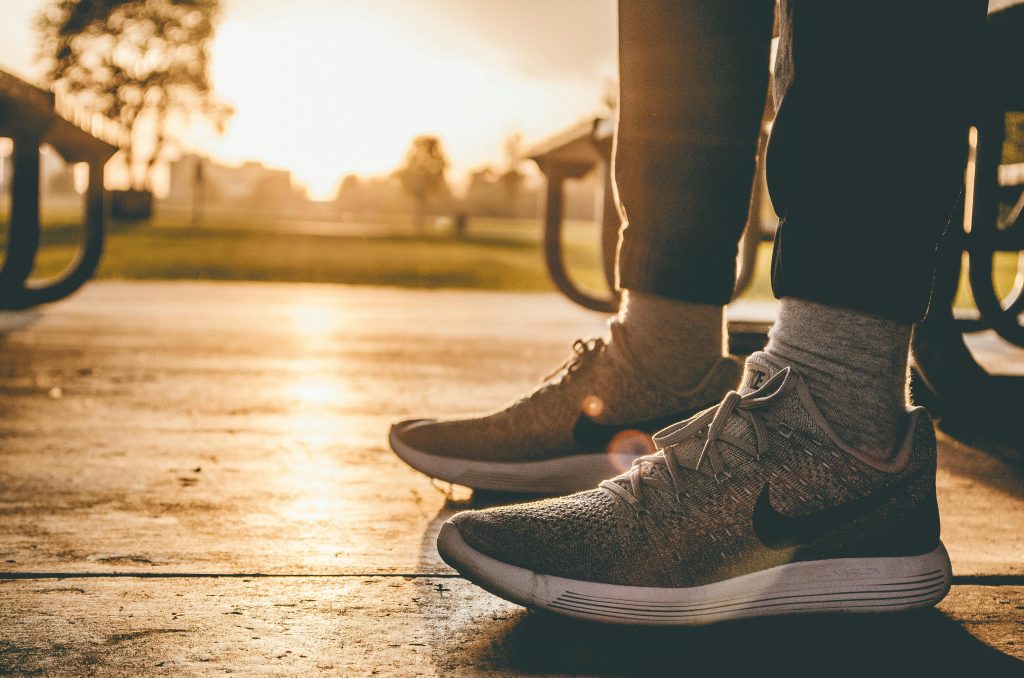 pexels-photo-2729899-2729899 Close-up of sneakers on person standing outdoors at sunrise in a Chicago park.